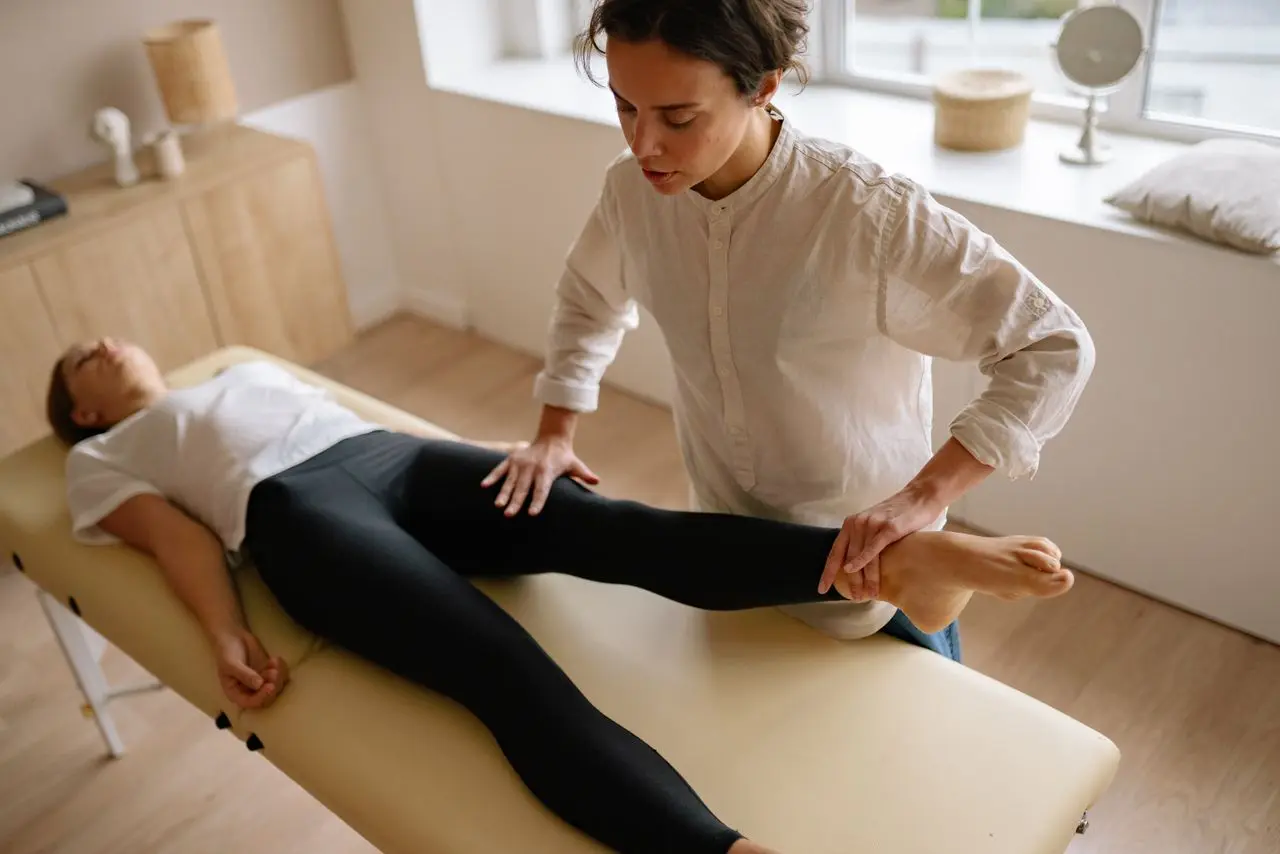 Une kinésithérapeute pendant une séance de rééducation